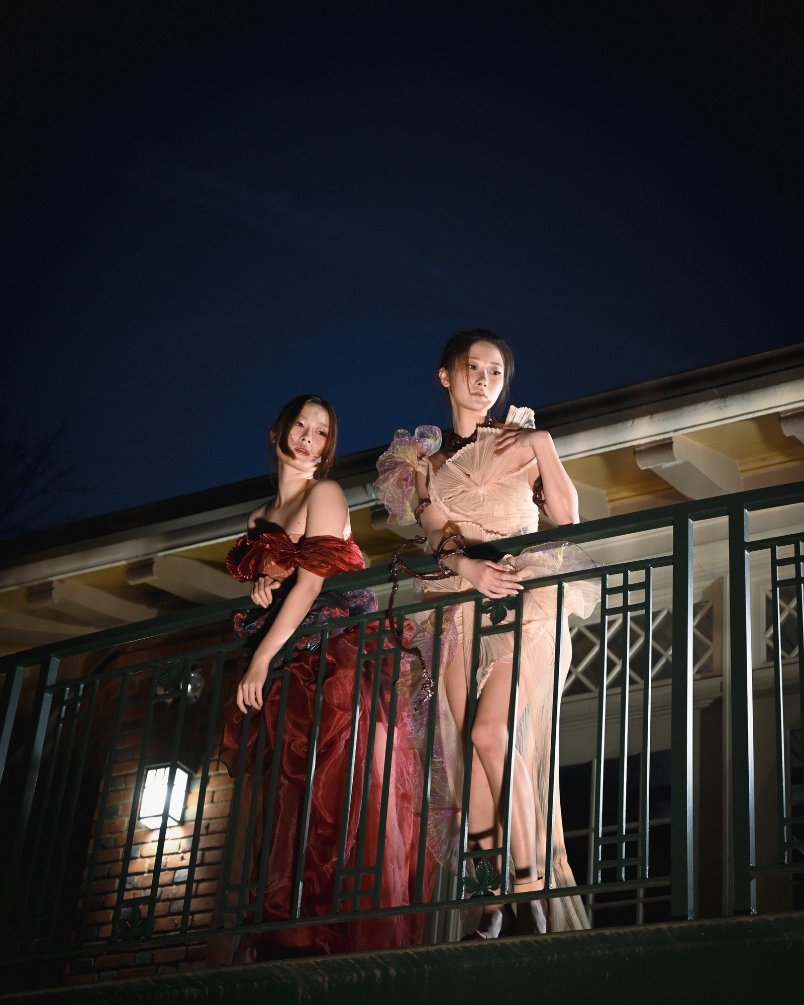 Two looks from the Balance line, photographed on a balcony at night
